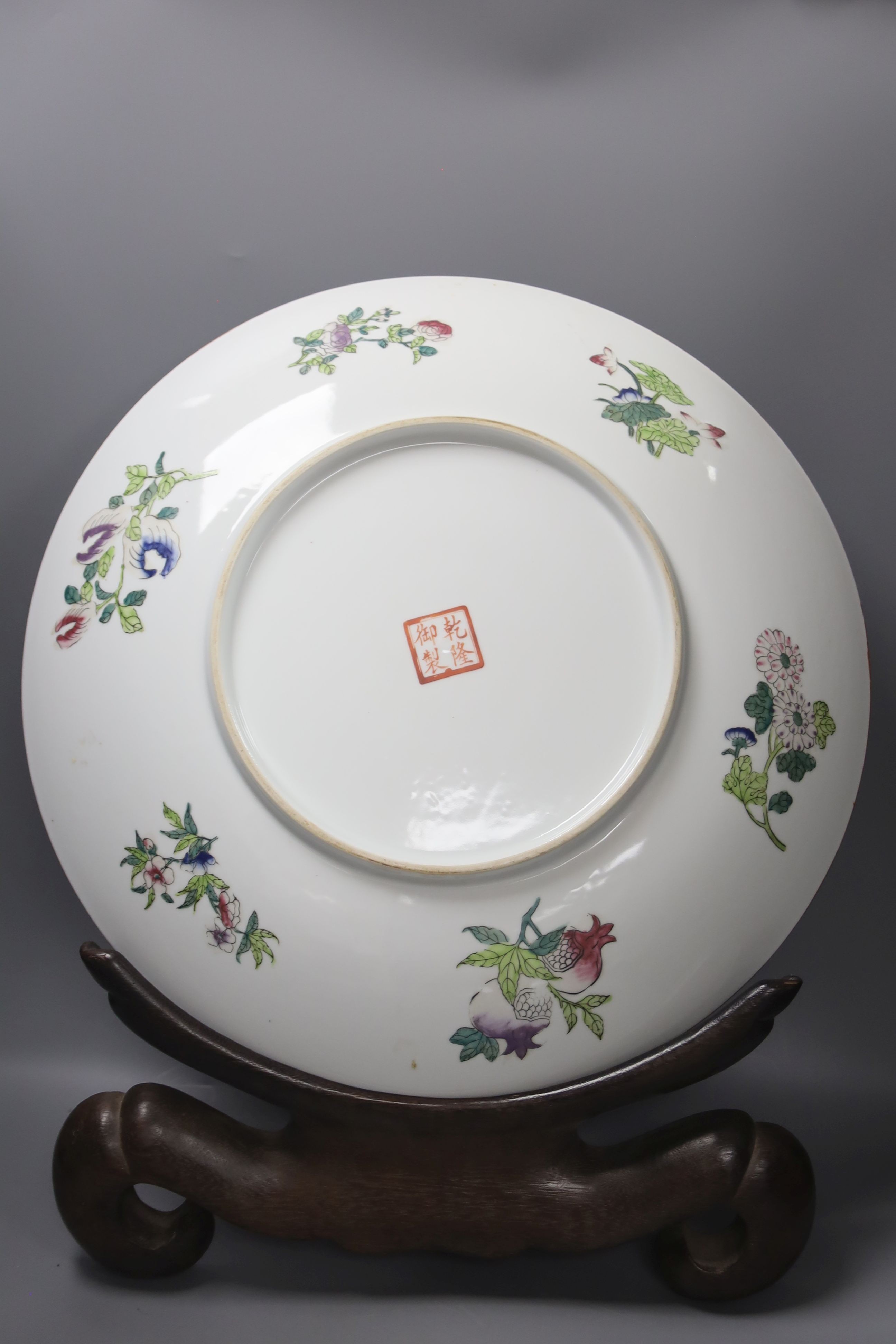 A large 20th century Chinese famille rose porcelain charger, diameter 46cm, on hardwood stand